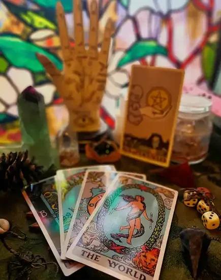 Tarot cards, palmistry hand, and crystals consecrated altar